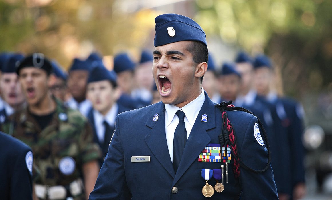 Michael Salinas a senior in the Air Force JROTC program at Bowie High School helps leads his fellow members at at the Veteran day parade on Congress in Austin, Texas.